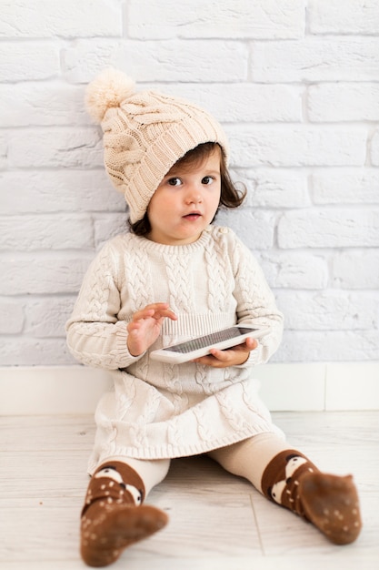 Cute little girl holding a phone