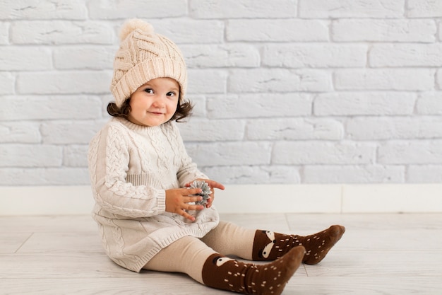 Cute little girl holding a pinecone