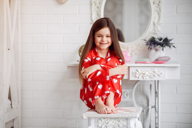 Free photo cute little girl at home in a pajamas