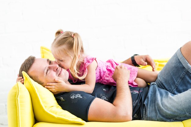 Cute little girl kissing to her father