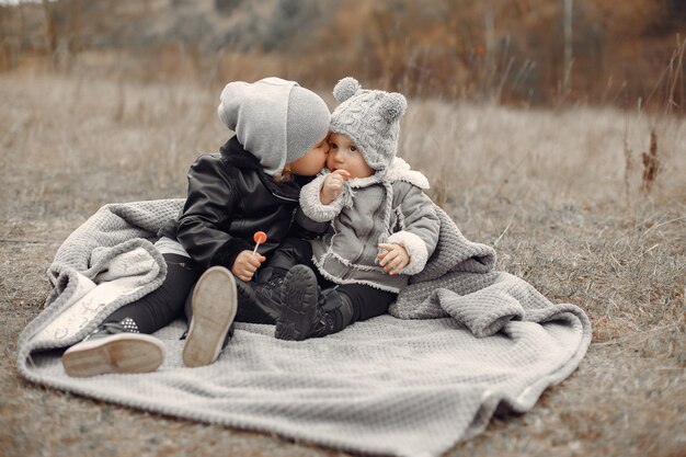 Cute little girl playing in a park with her sister