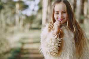 Free photo cute little girl playing in a summer forest