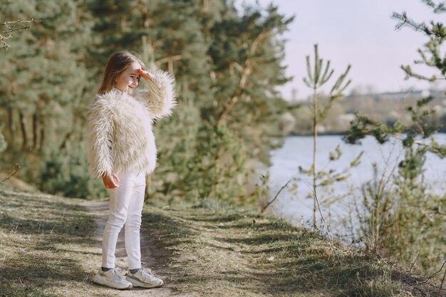 Cute little girl playing in a summer forest