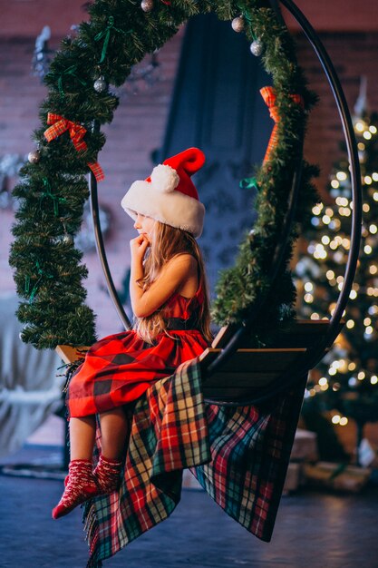 Cute little girl in santa hat and red dress