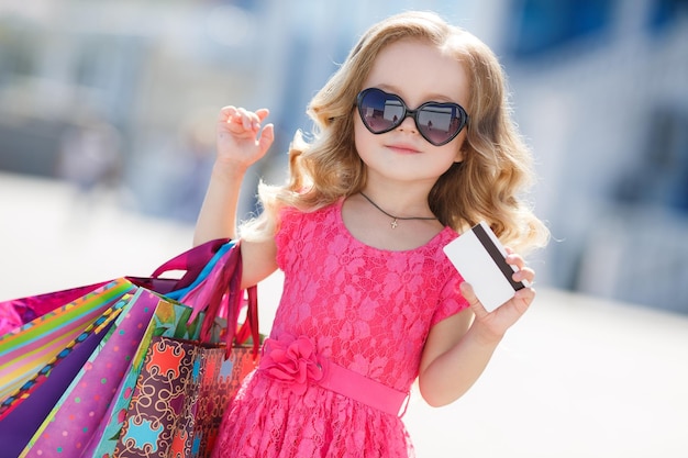 cute little girl shopping outdoors