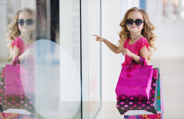 cute little girl shopping outdoors