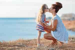 Free photo cute little girl with mother near the sea