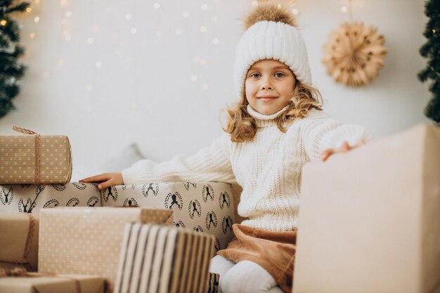 Cute little girl with plenty of christmas presents