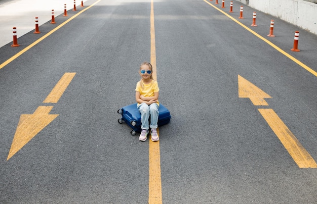 cute little girl with suitcase outdoor