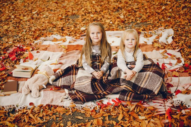Cute little girls in a autumn park