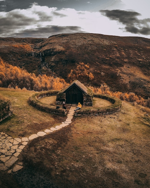 Free photo cute little hut with stone pathway on top of a hill