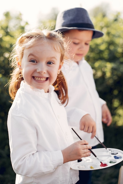 Cute little kids painting in a park