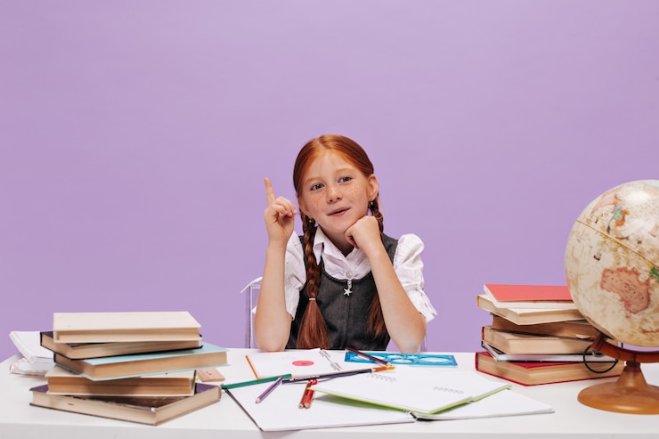 Free Photo cute little schoolgirl with freckles and modern pigtails in white shirt and sarafan has idea on purple isolated wall