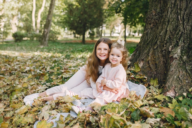 Cute little sisters playing  in a spring park