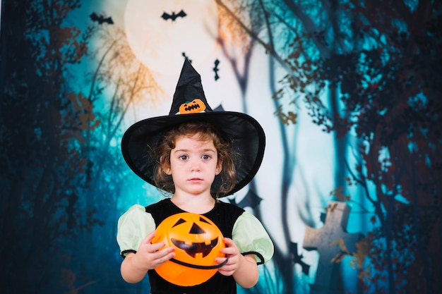 Cute little witch with basket