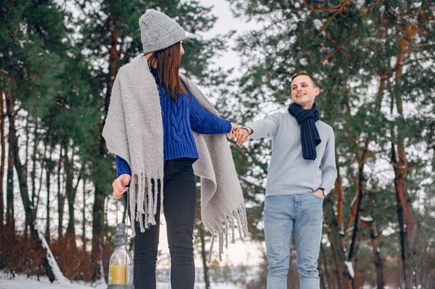 Cute and loving couple in a winter forest