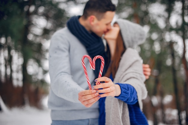 Cute and loving couple in a winter forest