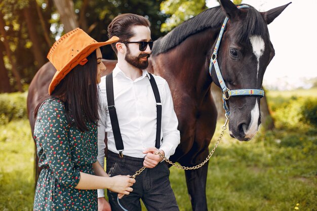 Cute loving couple with horse on ranch