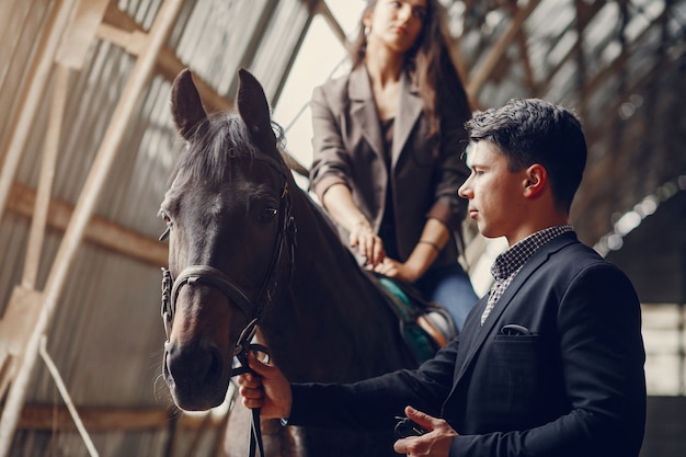 Cute loving couple with horse on ranch