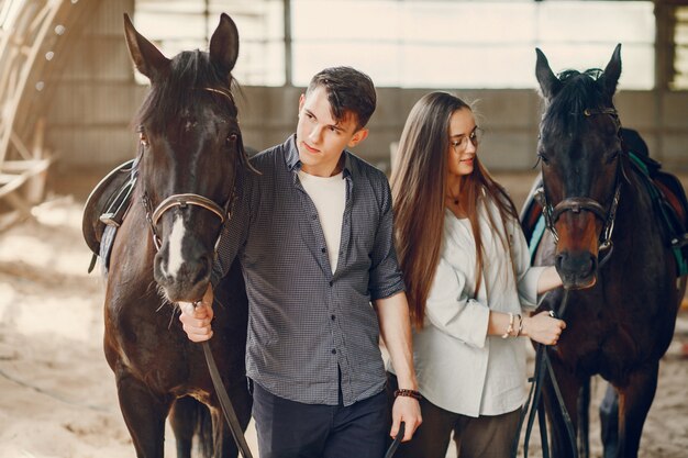 Cute loving couple with horse on ranch