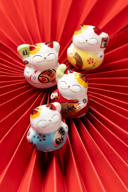 Cute lucky cats with red paper top view