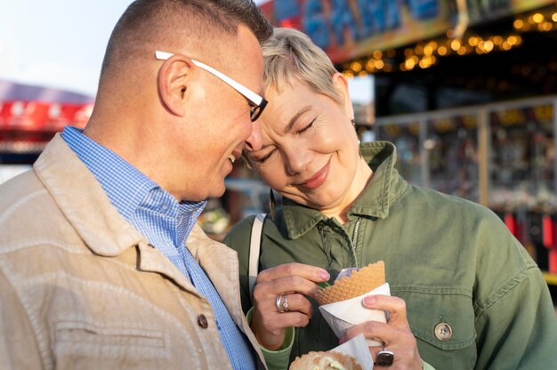 Cute middle age couple having a date in an adventure park