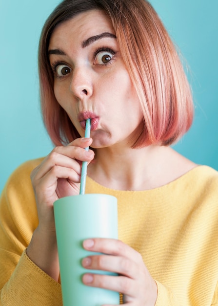 Free photo cute model sipping drink front view