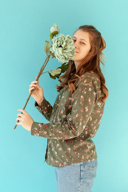 Free photo cute model smelling spring flower