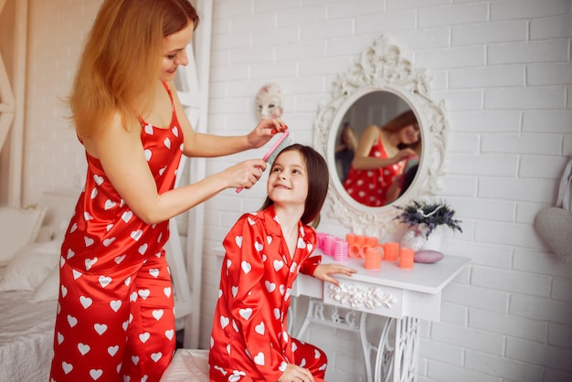 Cute mother and daughter at home in a pajamas