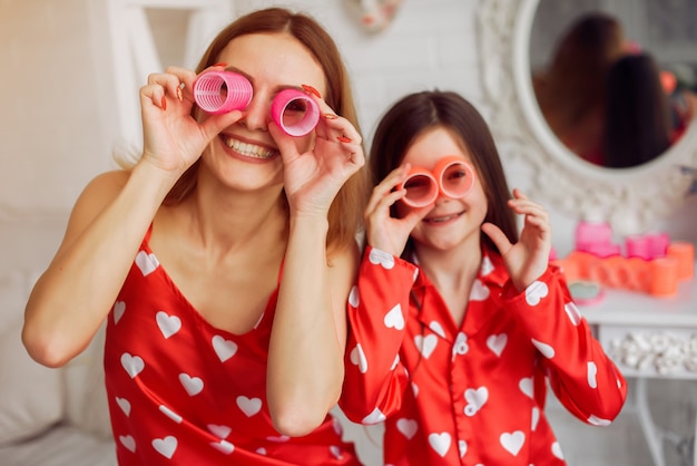 Cute mother and daughter at home in a pajamas