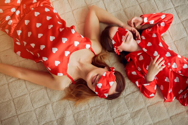 Cute mother and daughter at home in a pajamas