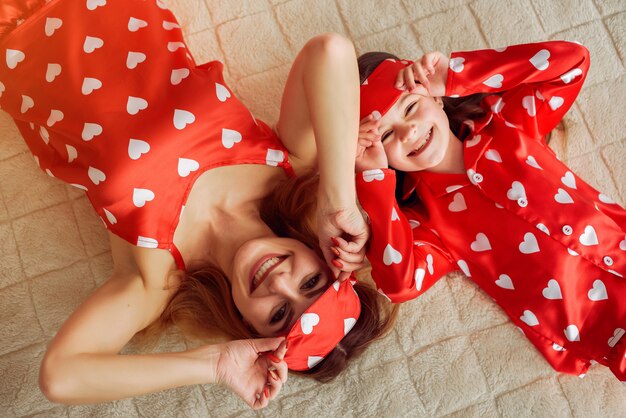 Cute mother and daughter at home in a pajamas