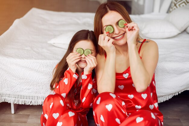 Cute mother and daughter at home in a pajamas