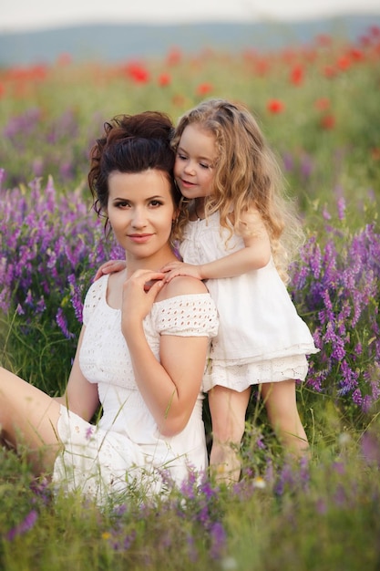 cute mother and daughter outdoor field portrait
