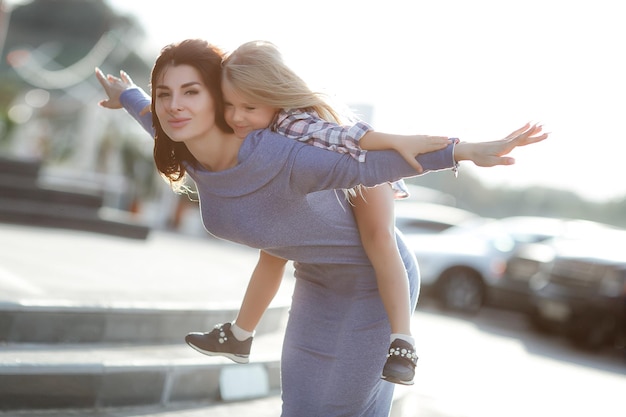 Free photo cute mother and her daughter outdoor