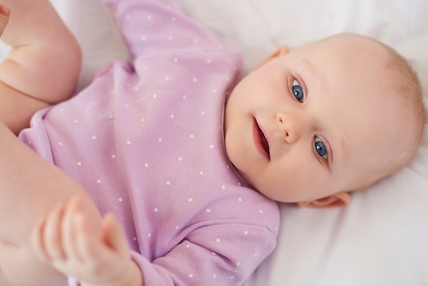 Cute newborn lying down on the bed