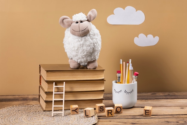 Free photo cute plush toy and books arrangement