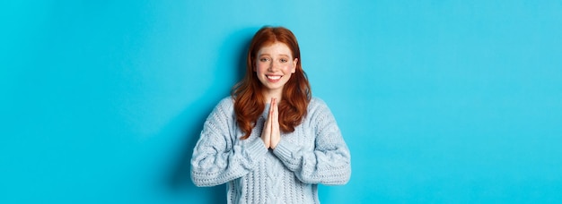 Free photo cute redhead girl saying thank you smiling and looking at camera expressing gratitude standing again