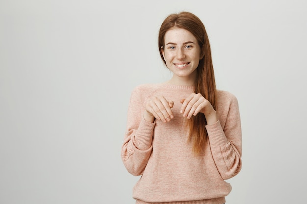 Cute redhead smiling girl aping puppy paws