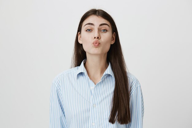 Cute romantic woman fold lips for kiss