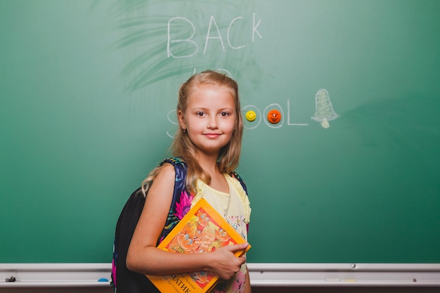 Free photo cute schoolgirl with book