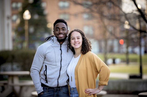 Cute selective focus shot of two friends smiling and posing together