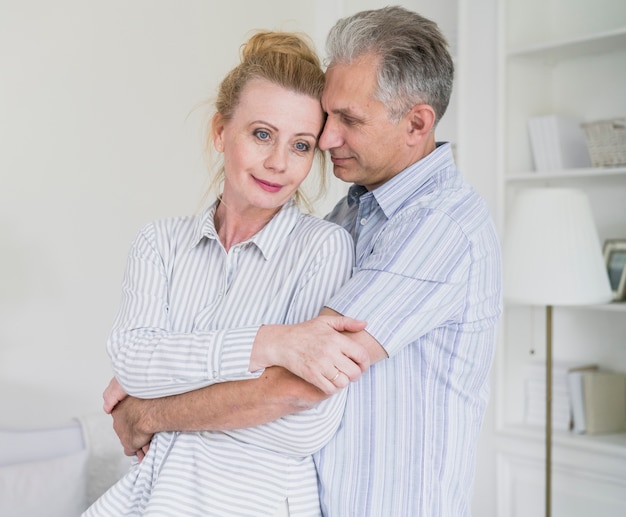 Free photo cute senior couple holding each other