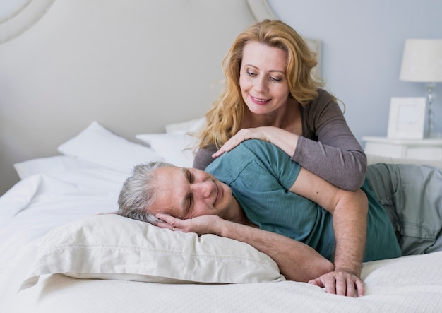 Cute senior couple together in bed