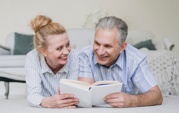 Cute senior couple together with a book