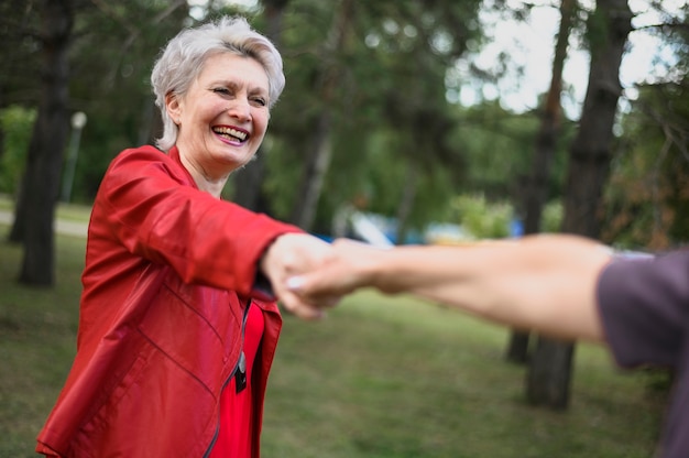 Free photo cute senior women holding hands