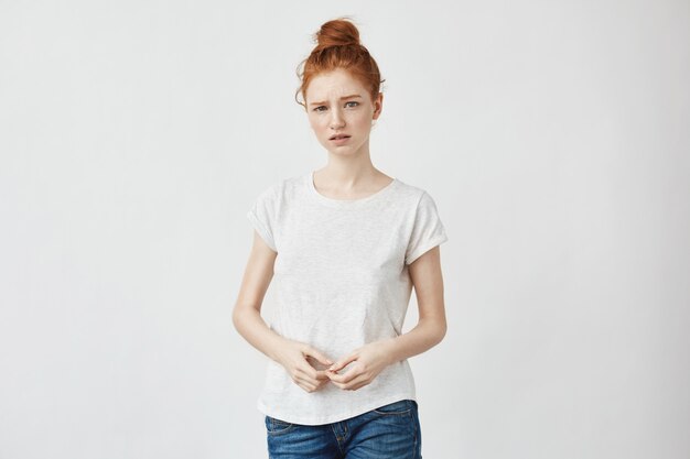 Cute shy redhead woman with hair bun.