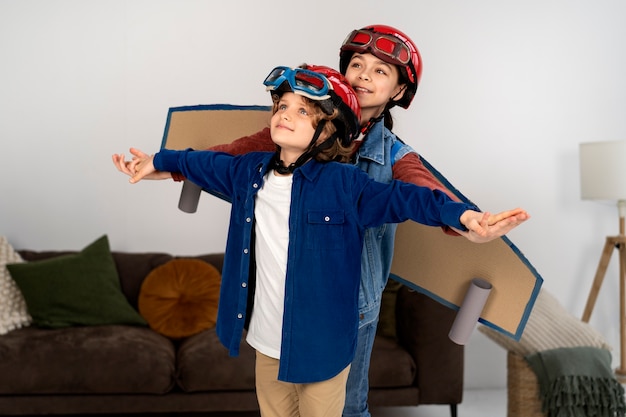 Free photo cute siblings playing with flying goggles