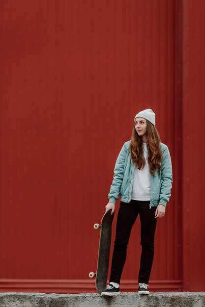 Cute skater girl and her skateboard