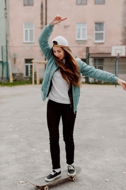 Free photo cute skater girl and her skateboard